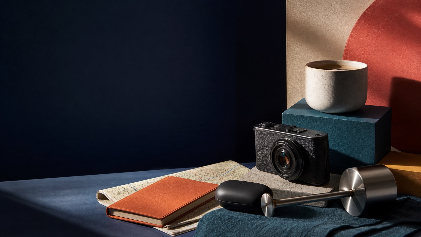 Camera, notebook, lamp and everyday objects arranged as discoveries for home, desk and travel